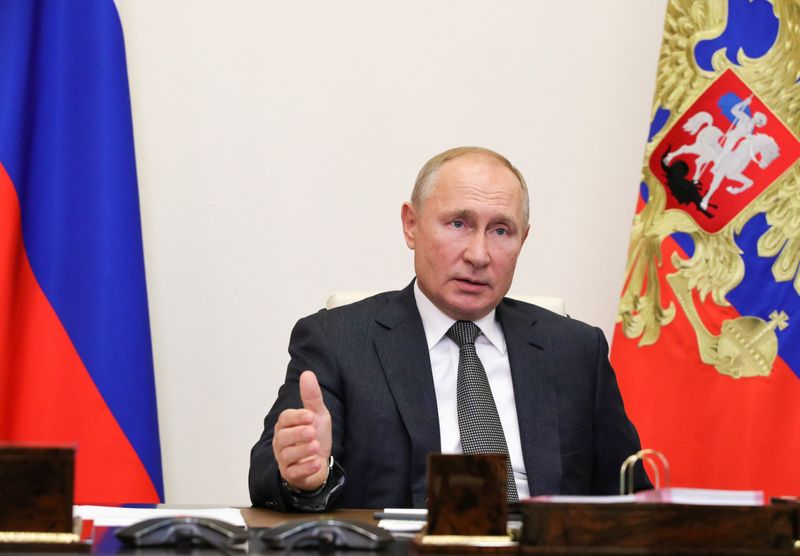 Russian President Vladimir Putin takes part in a meeting with