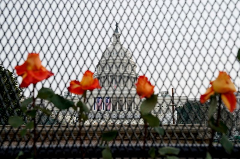 Flowers are placed in security fencing around the U.S. Capitol