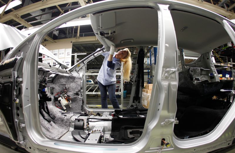 An employee works at the assembly line of the Ford