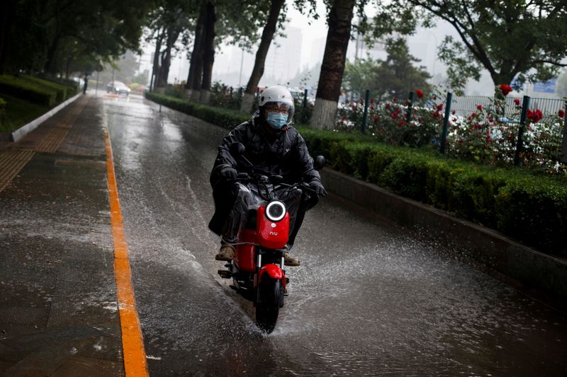 FILE PHOTO: A man rides a Niu electric scooter through