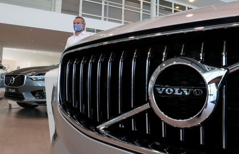 An employee at a Volvo car dealer, wearing a protective