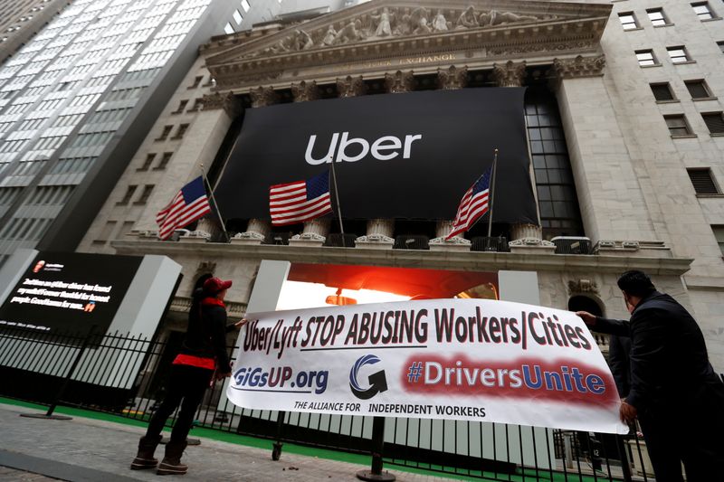 FILE PHOTO: Protestors display banner during Uber Technologies Inc’S IPO