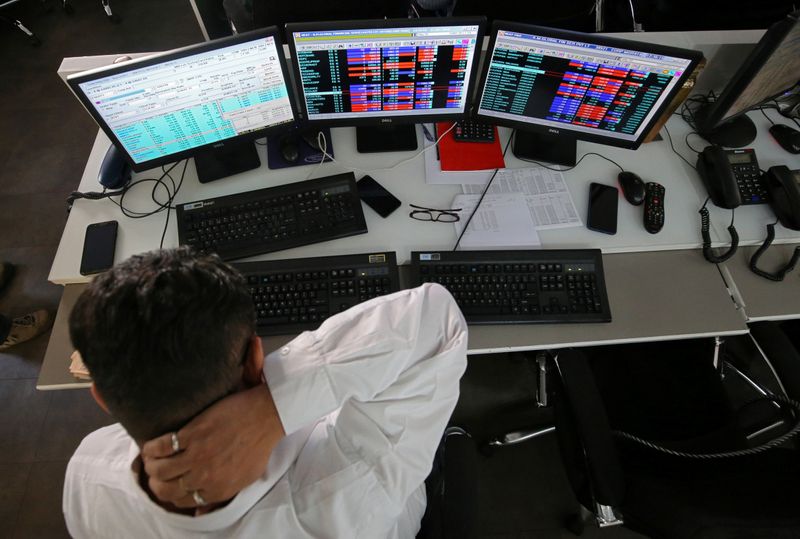 A broker reacts while trading at his computer terminal at