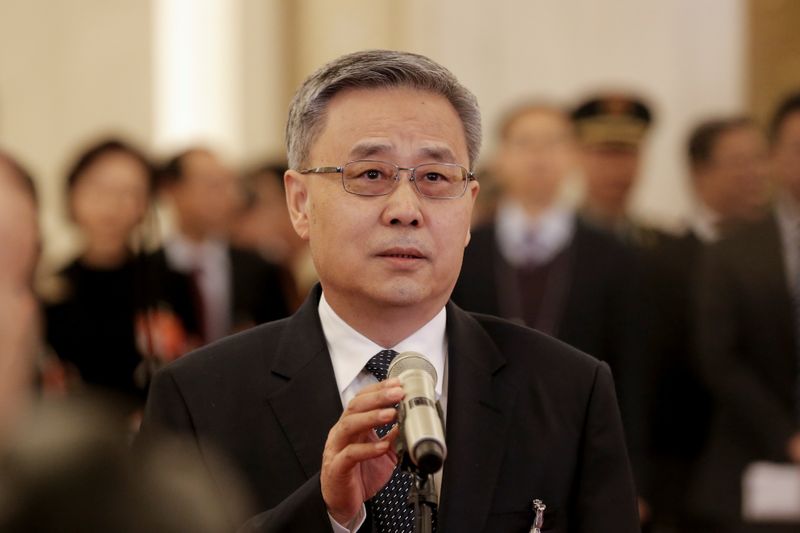 China’s top banking regulator Guo Shuqing speaks to reporters on
