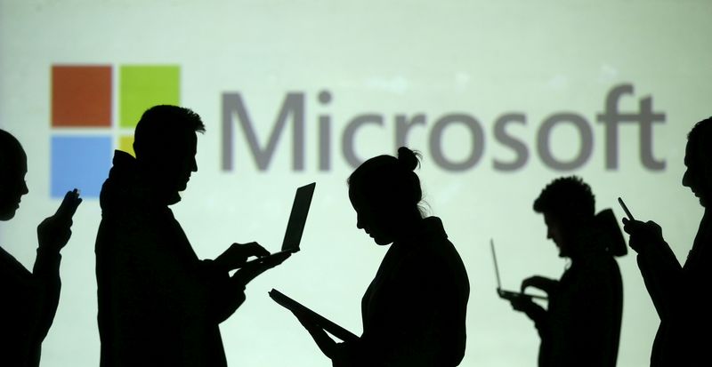 FILE PHOTO: Silhouettes of laptop and mobile device users are