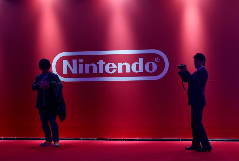 FILE PHOTO: People stand in front of Nintendo’s logo at