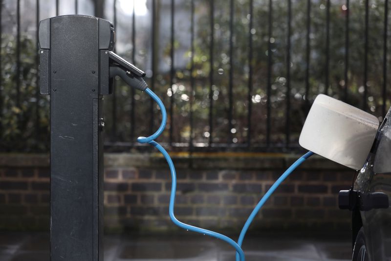 FILE PHOTO: A car is plugged in at a charging