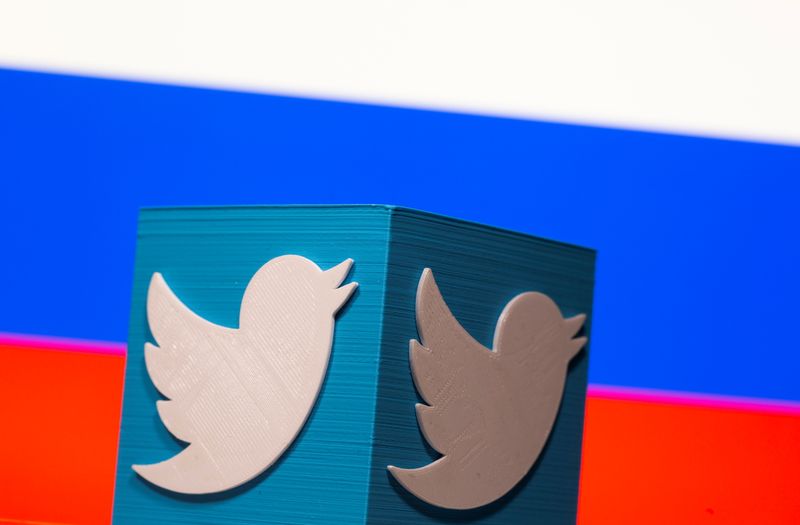 A 3D-printed Twitter logo is pictured in front of a