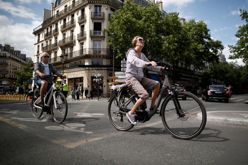 FILE PHOTO: A woman rides an electric bike as the