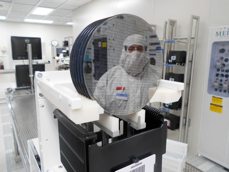 A worker is seen at a semiconductor fabrication facility owned