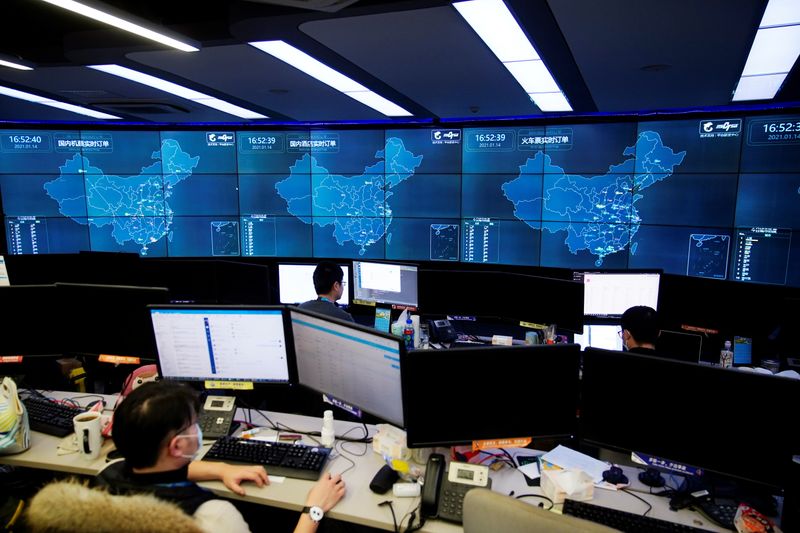 Employees work at a network operating center of an online