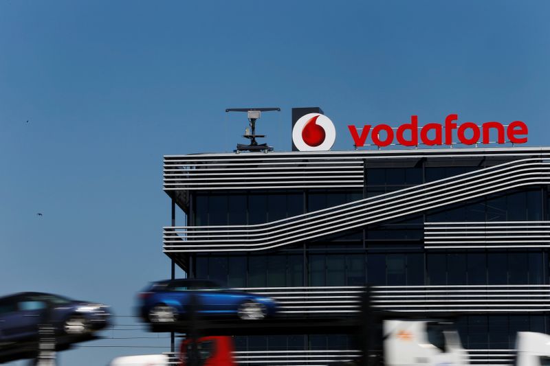 FILE PHOTO: A truck carrying cars speeds past the headquarters