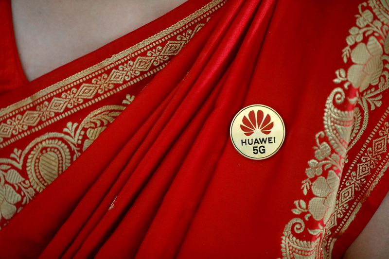 FILE PHOTO: Huawei’s logo is seen on a badge pinned