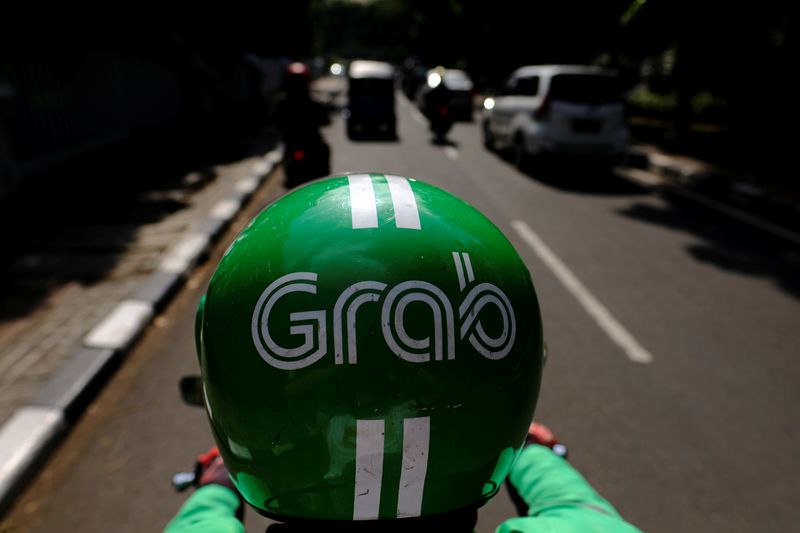 A Grab motor driver is seen in a street in