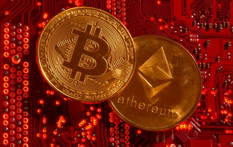 Representations of cryptocurrencies Bitcoin and Ethereum are placed on PC