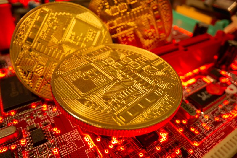 Representations of the virtual currency stand on a motherboard in