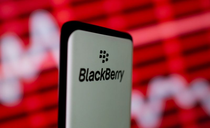 The Blackberry logo is seen on a smartphone in front