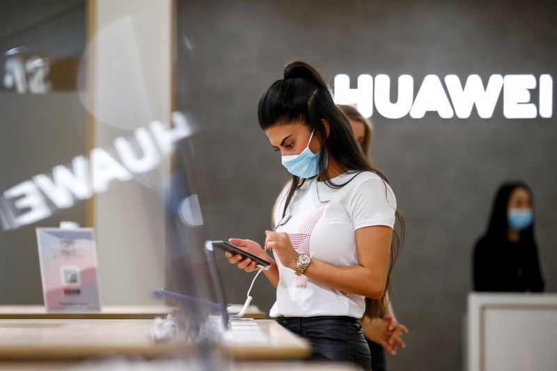 FILE PHOTO: An employee uses a Huawei P40 smartphone at