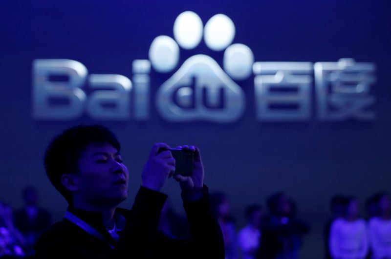 A man takes pictures at the 2018 Baidu World conference