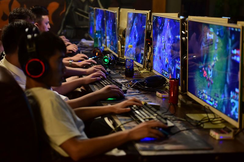 FILE PHOTO: People play online games at an internet cafe