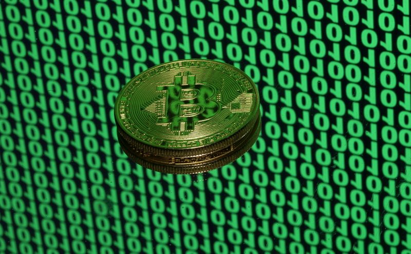 FILE PHOTO: Bitcoin token is seen placed on a monitor