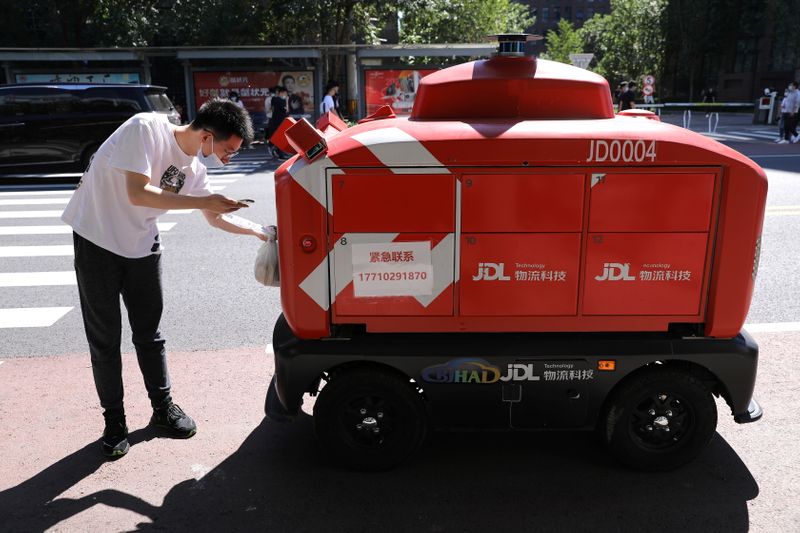 Autonomous delivery vehicle by JD Logistics operates on a street