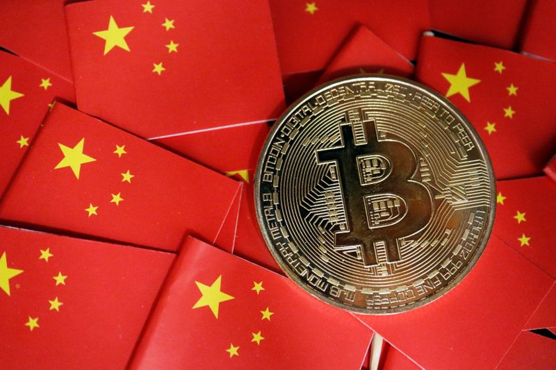 Picture illustration of China’s flags and cryptocurrency