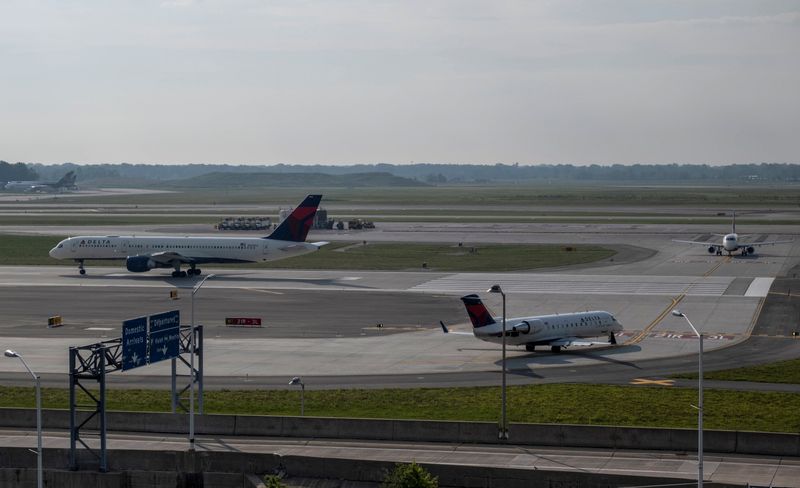 FILE PHOTO: Delta Airlines passenger jets taxi on a runway