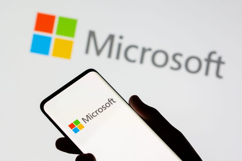 FILE PHOTO: Smartphone is seen in front of Microsoft logo