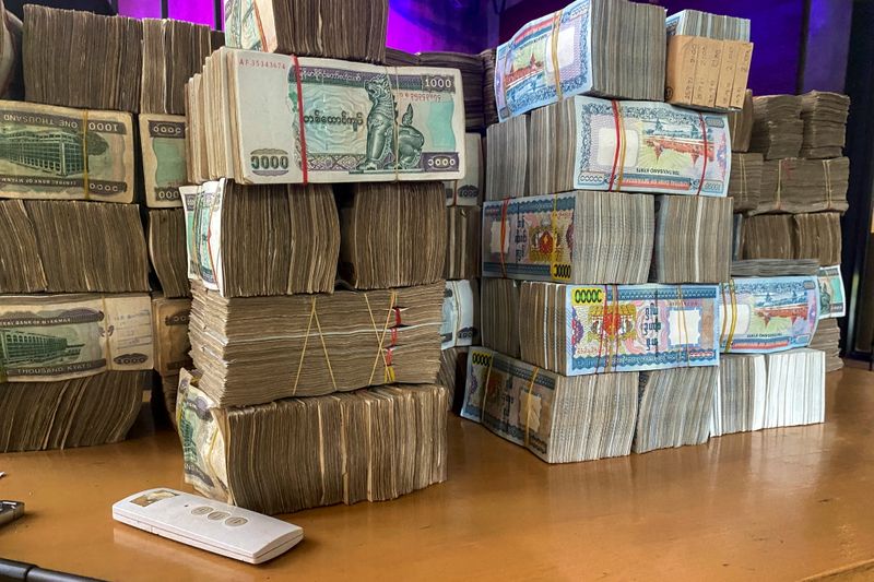 Myanmar banknotes are seen during an illegal exchange inside a