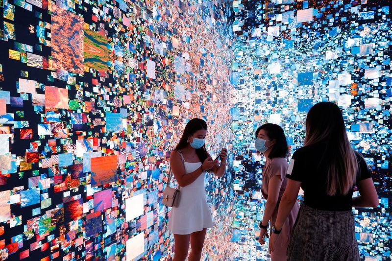 Visitors are pictured in front of an art installation which