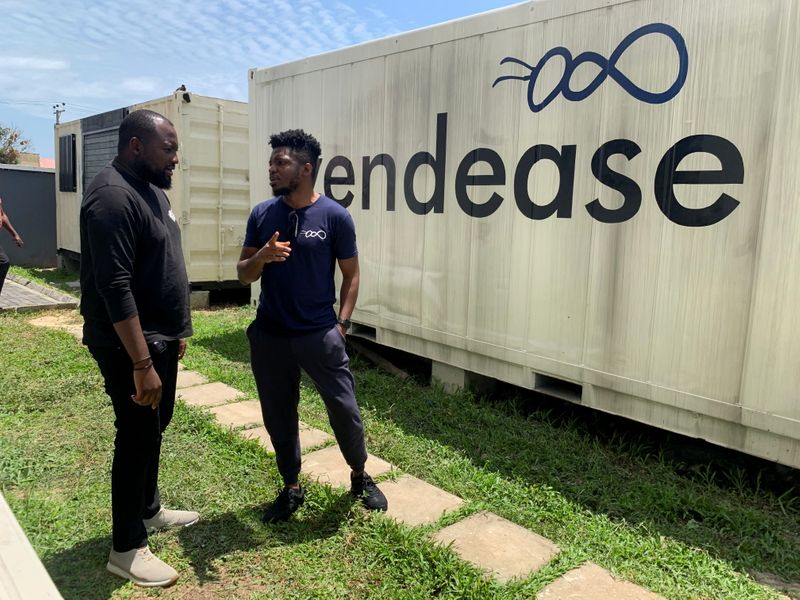Vendease co-founders chat outside their office in Lagos