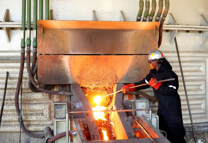 FILE PHOTO: A worker attends to machinery at a smelter