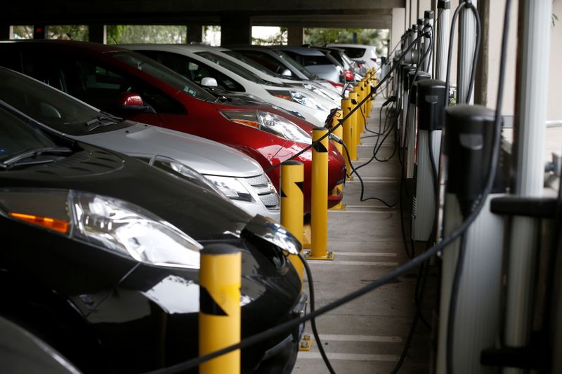 FILE PHOTO: Electric cars sit charging in a parking garage