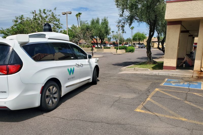 Driverless Waymo Chrysler Pacifica minivan partially blocks access to a