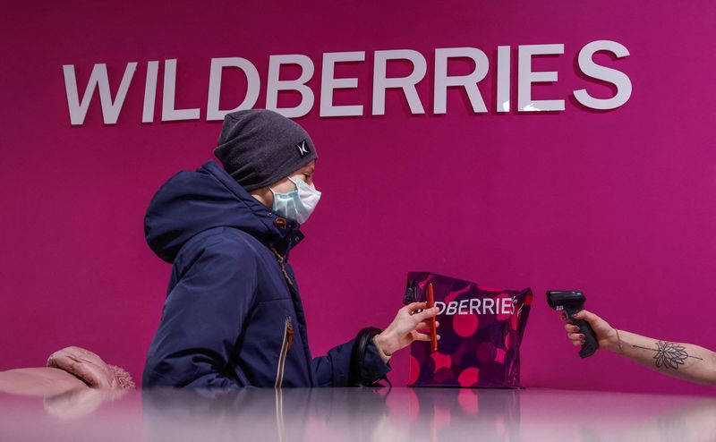 Employee of Wildberries online retailer scans a code on a