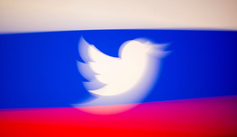 FILE PHOTO: Twitter logo and a Russian flag are displayed