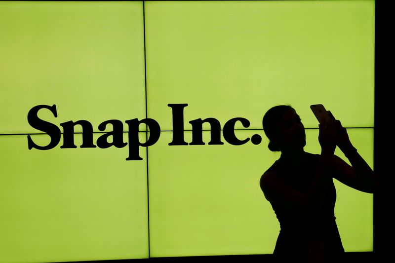 FILE PHOTO: A woman stands in front of the logo
