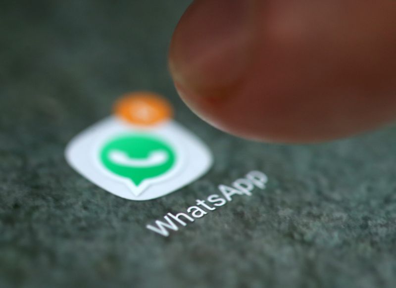 The WhatsApp app logo is seen on a smartphone in