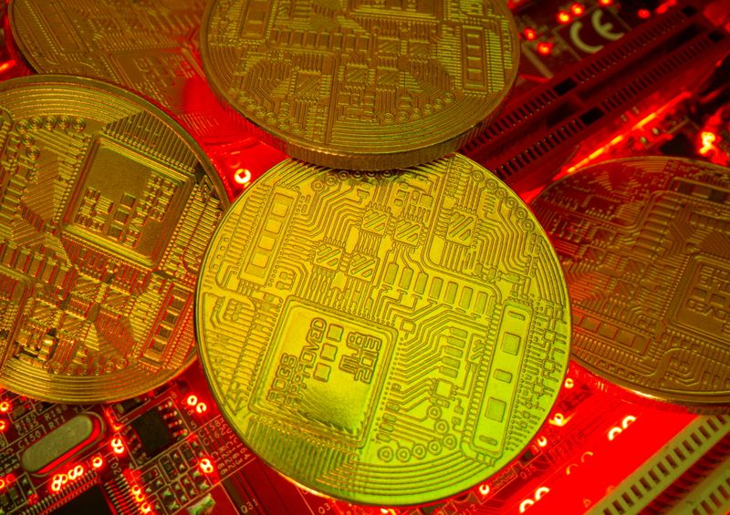 Representations of the virtual currency stand on a motherboard in