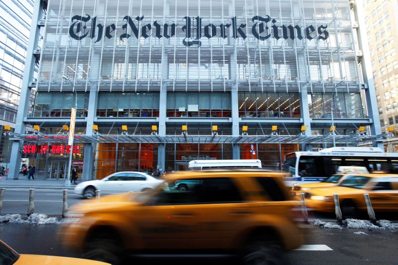FILE PHOTO: Vehicles drive past the New York Times headquarters
