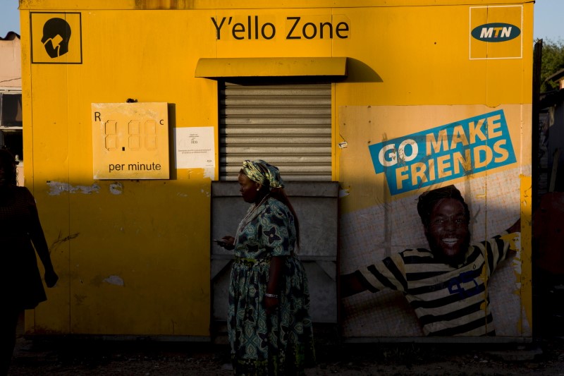FILE PHOTO: A resident walks past an MTN telecom shop