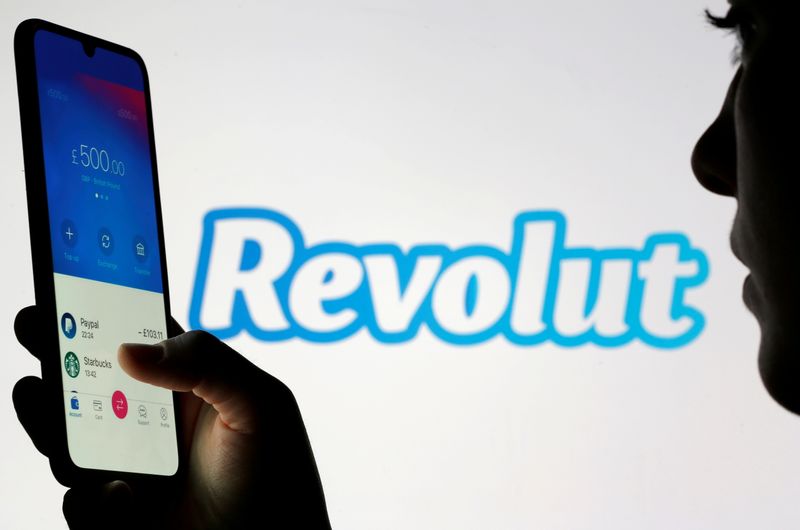 FILE PHOTO: Woman holds smartphone with Revolut app in front