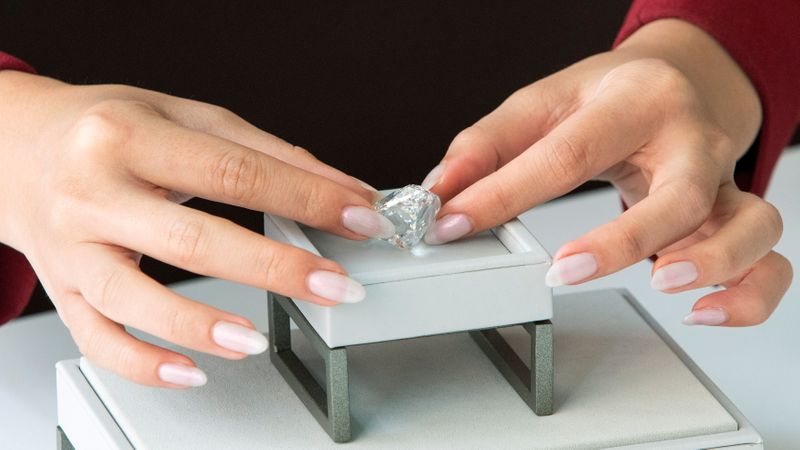 An employee of Sotheby’s displays a rare flawless 100+ carat