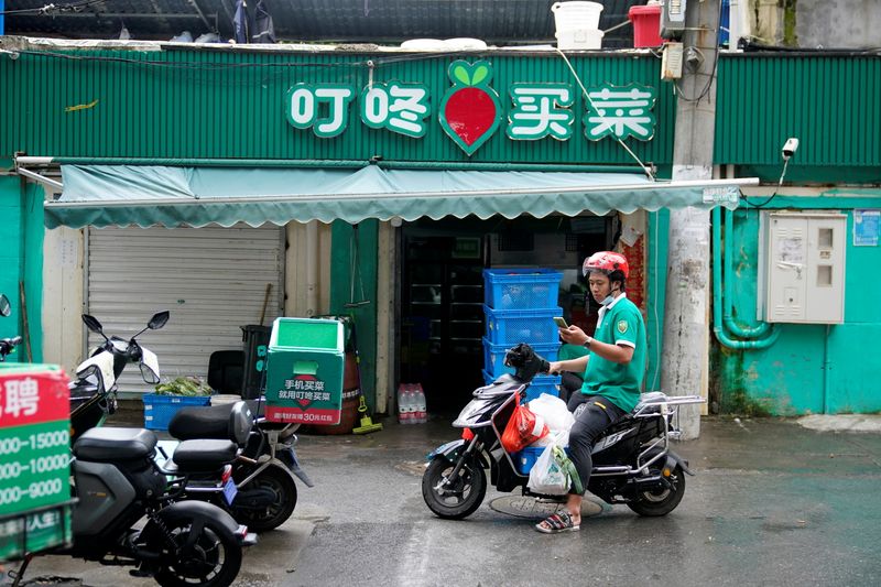 A delivery worker of Chinese online grocery Dingdong Maicai works