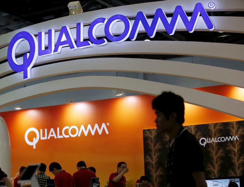 FILE PHOTO: Qualcomm’s logo is seen at its booth at