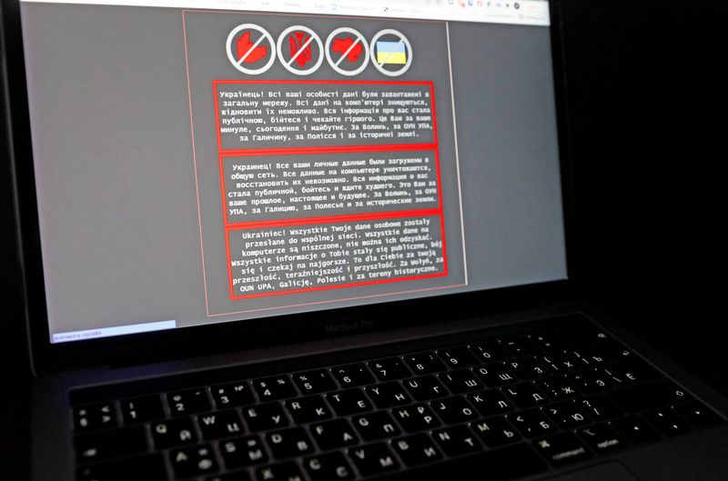 A laptop screen displays a warning message on the official website of the