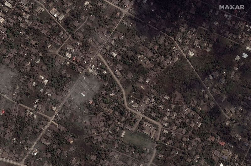 A satellite image shows ash covered homes and buildings after