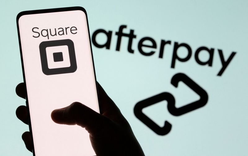 Smartphone with Square logo is seen in front of displayed