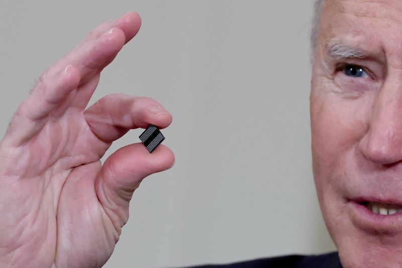 FILE PHOTO: FILE PHOTO: U.S. President Biden holds a semiconductor